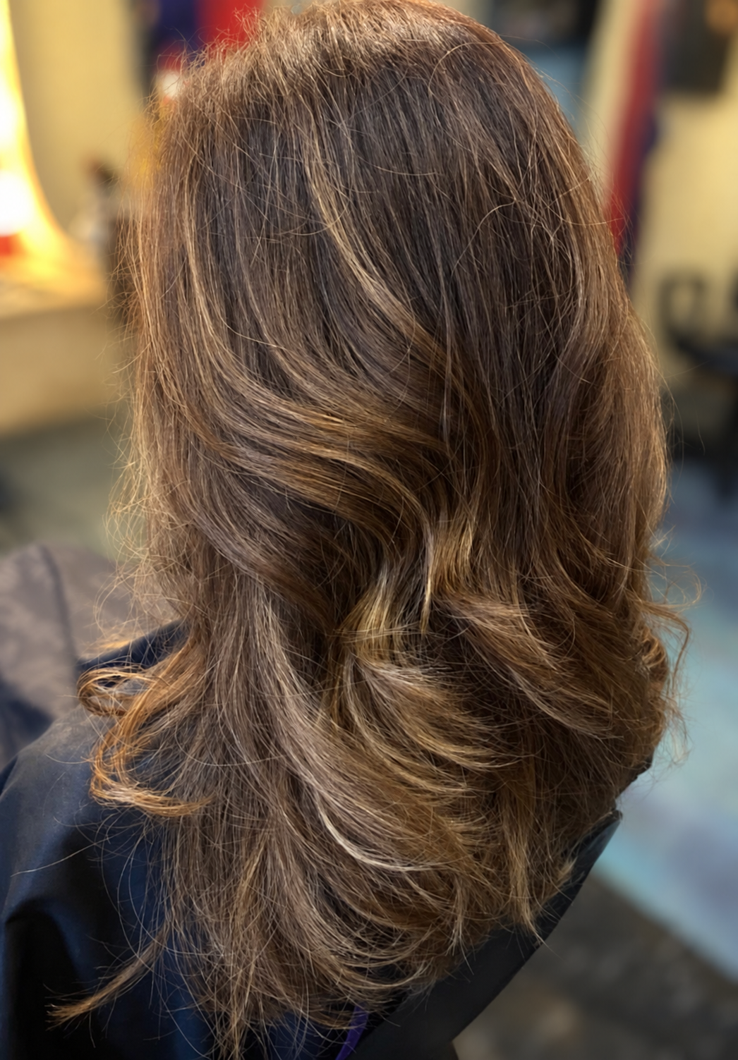 Brunette hair with soft waves and lighter ribbons of color, by Kellie