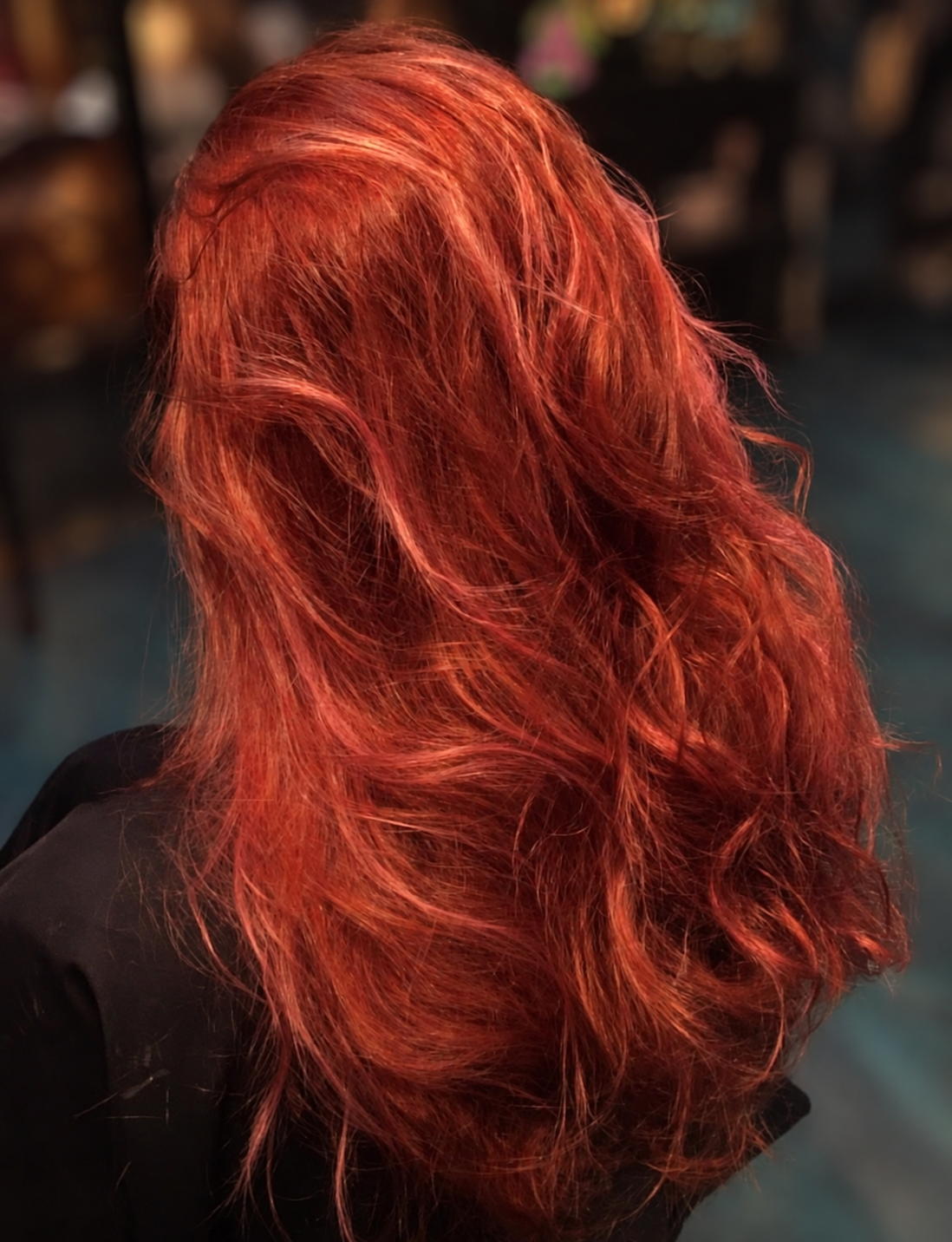 Rich copper-red hair styled in loose waves by Kellie